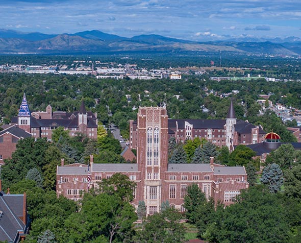 aerial shot over du campus with mountains in the background 