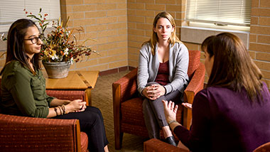 2 women speaking with counselor