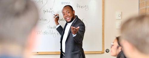 professor at whiteboard during a lecture