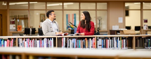 students talking in the library
