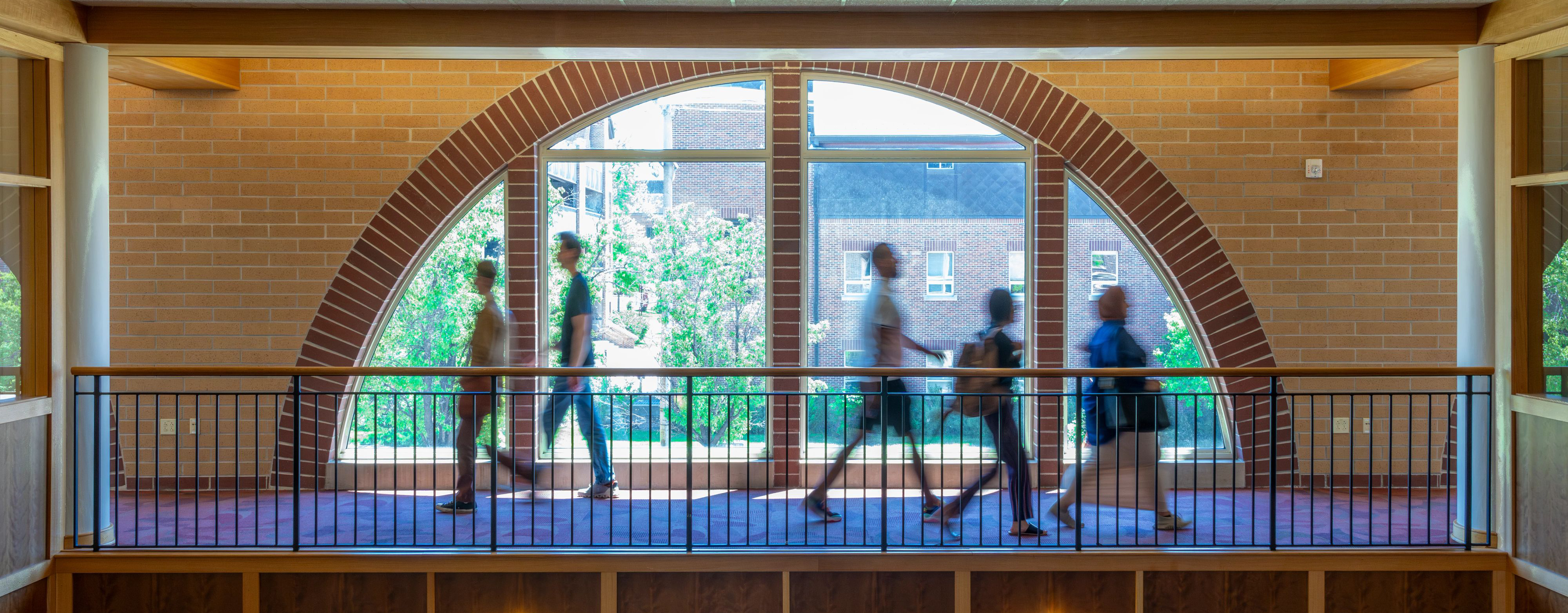 students walking in the interior of the Morgridge college building