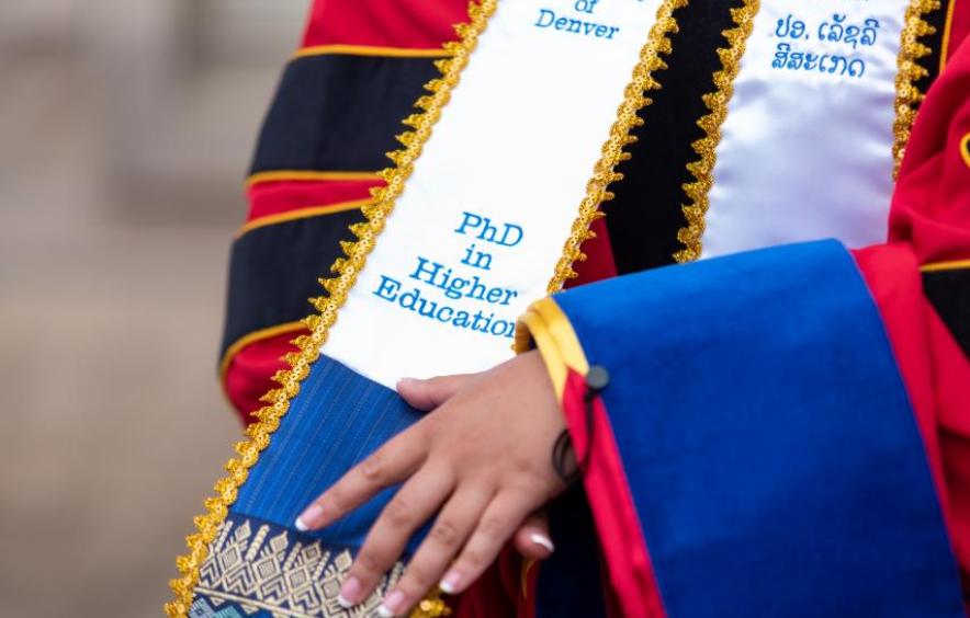 Graduate student wearing HED hooding regalia