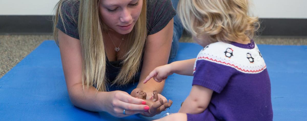 teacher with a kid on the floor