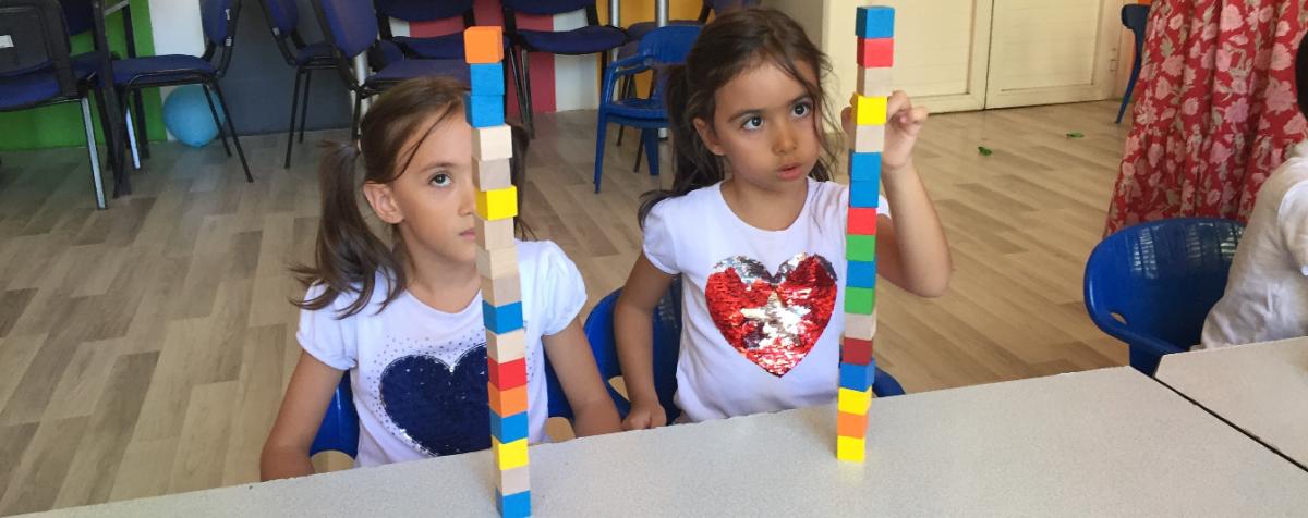 two students with stacks of blocks