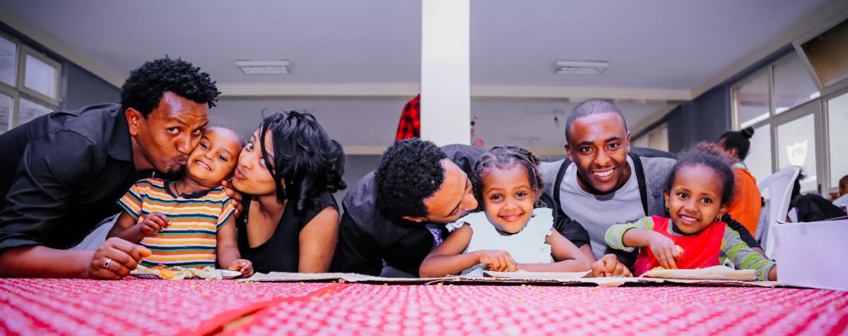 A Black family at sitting at a table