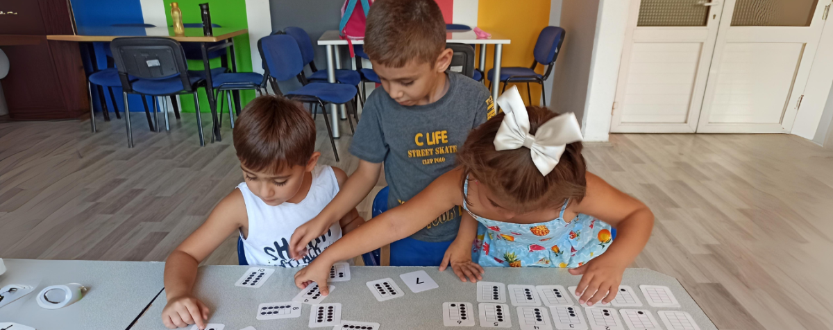 Young children manipulate counting cards