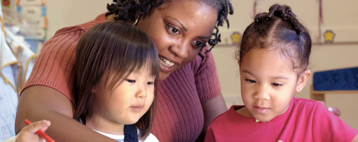 Teacher and two young children