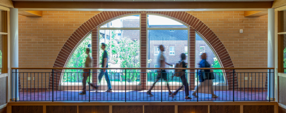 students walking through the Morgridge building