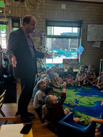 Jared Polis in early learning classroom with students